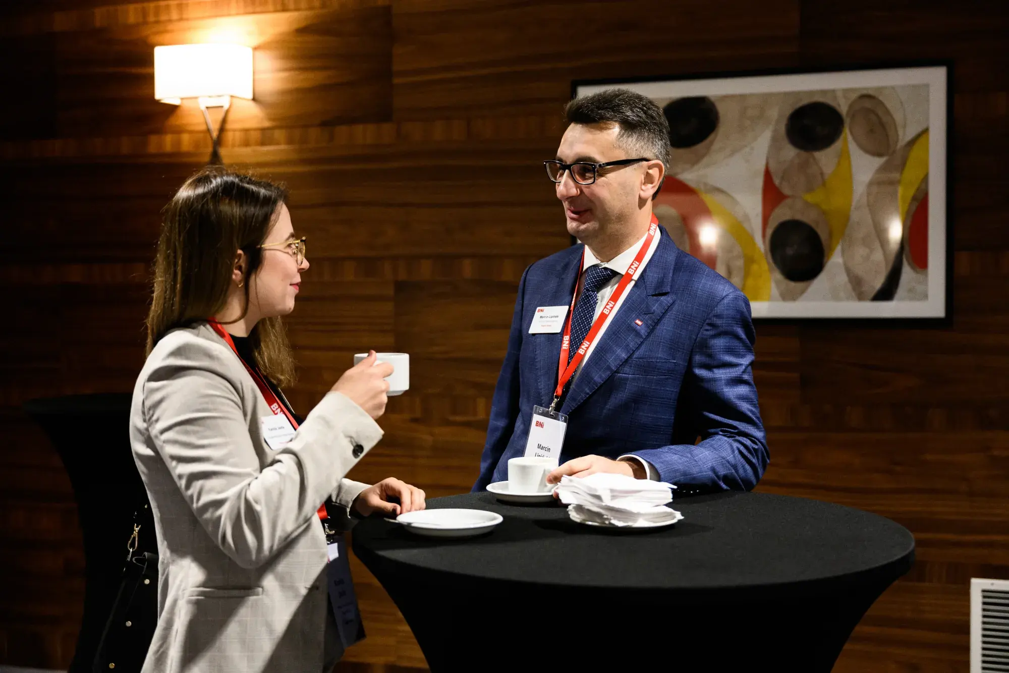 Two BNI Members talk over coffee during a meeting break