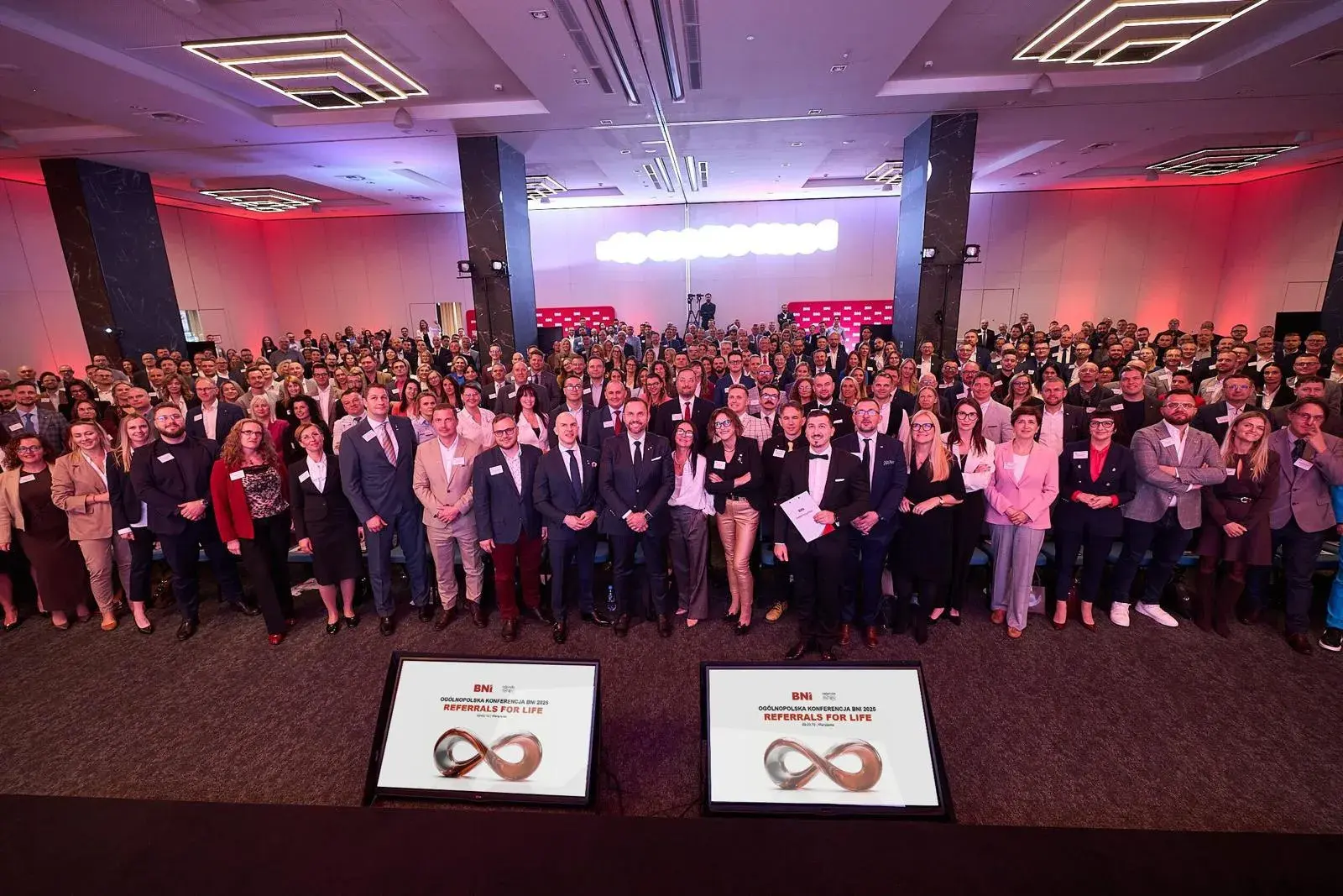 A hall full of participants at a large BNI event