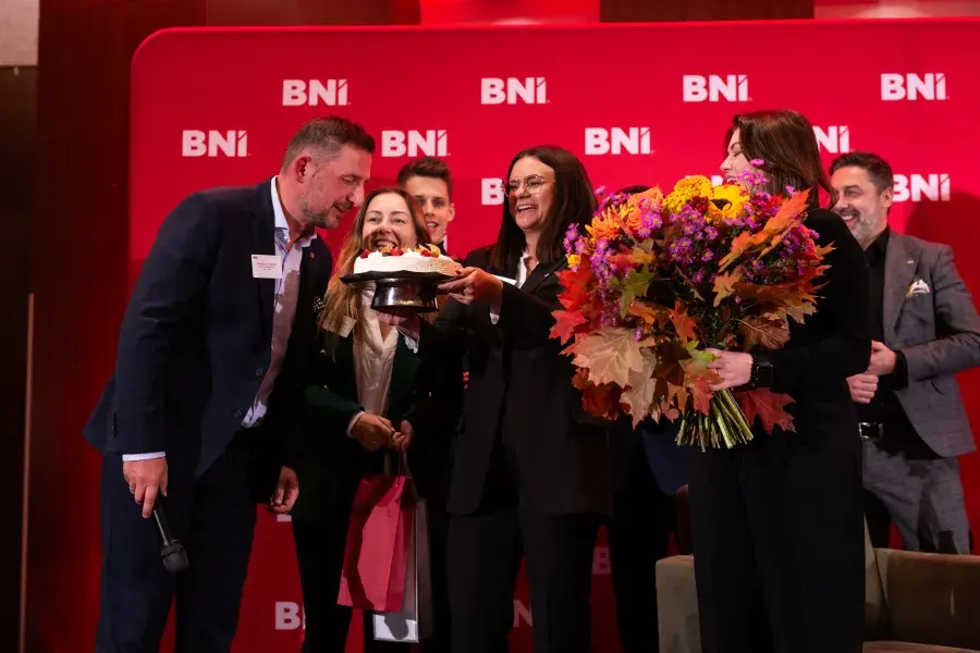 A Chapter anniversary — cake and flowers on stage