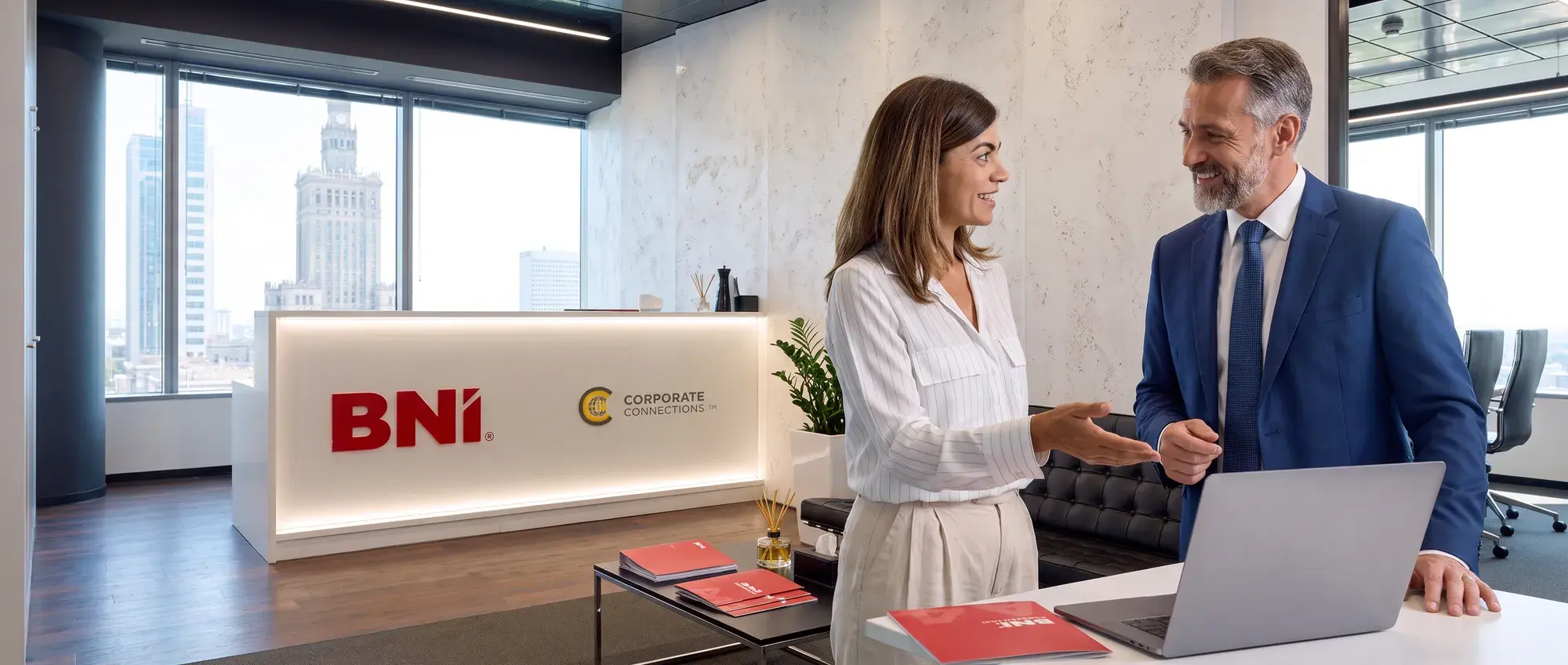 A National Office employee talks with a visitor at the BNI reception desk