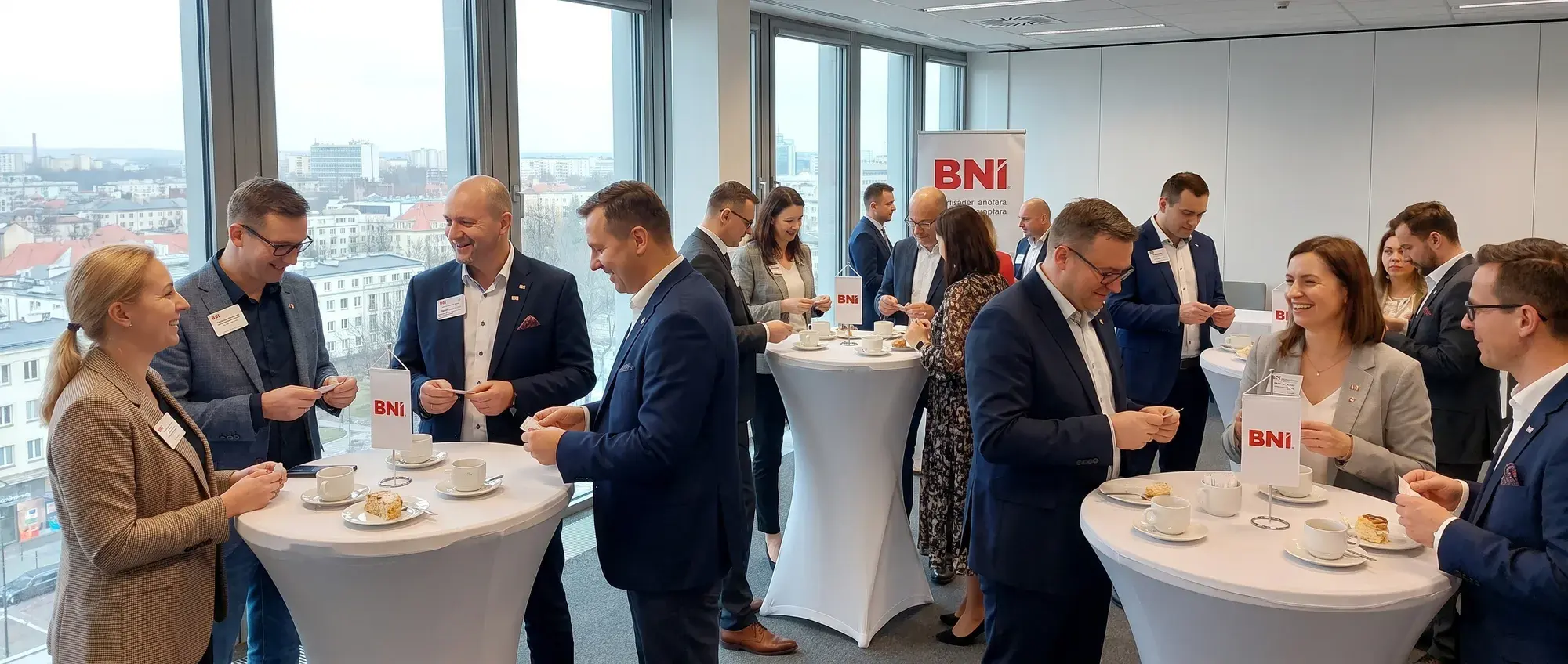 A morning BNI Chapter Meeting: Members talk at high tables over coffee