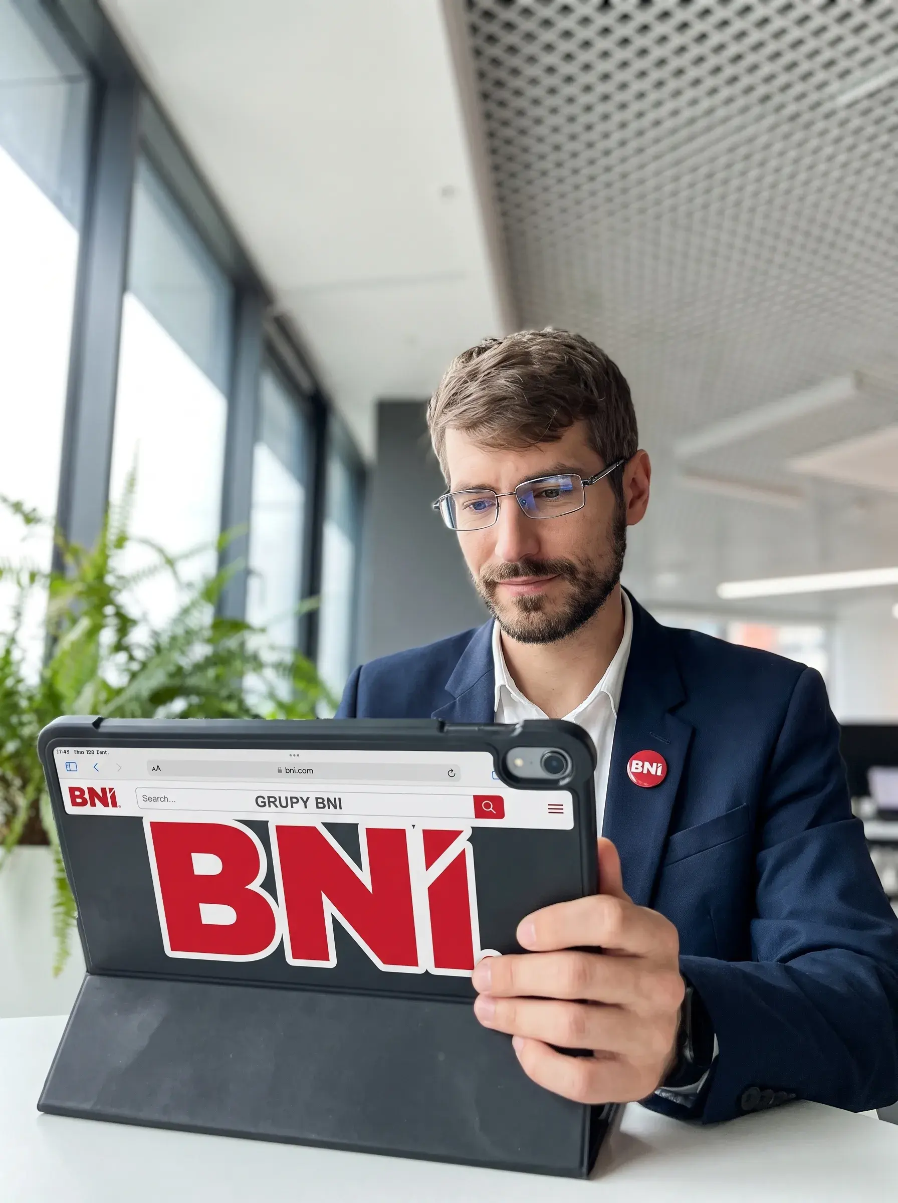 A BNI Member browses BNI Chapter materials on a tablet